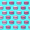 Seamless pattern of pink sweet macarons cakes on blue background. French macaroons. Junk food background