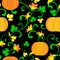 Seamless pattern. Pumpkin with twisted stems, leaves and flowers on a black background.