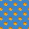 Seamless pattern of raw yellow eggs yolks on a blue background. Broken egg repeating ornament backdrop, Easter banner