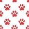 Seamless pattern of red cat paws with white polka dots on white background