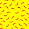 Seamless pattern. Red hot chile peppers on yellow background. Icon red spicy pepper. Vector