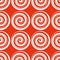 Seamless pattern with red and white spirals on a red background