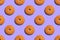 Seamless pattern with round cookies on a violet background