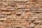 Seamless pattern of sandstone facade on a textured stone wall brick backdrop.