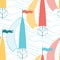 Seamless pattern with sea waves and cute colored sailing boats.