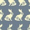 Seamless pattern with sitting yellow rabbits and hares. Design for wallpaper, textiles, Easter background
