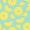 Seamless pattern from sliced pineapple pieces on a green background.