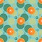 Seamless pattern with sprinkled oranges and simple geometric shapes in circles on a blue background.