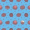 Seamless pattern with tasty looking chocolate pralines on bright blue background