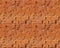 Seamless pattern. The texture of the old broken brick. Copper color.