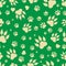 Seamless pattern of traces of dog`s paws.