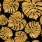 Seamless pattern of tropical gold monstera leaves