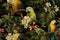 A seamless pattern with vibrant exotic jungle parrots, assorted floral designs, and branches, all set against a