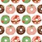 Seamless pattern of watercolor colored glazed Christmas donuts