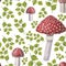 Seamless pattern of watercolor fly agarics and green leaves isolated on white background