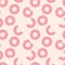 Seamless pattern of whole doughnuts and parts of bitten donuts with glaze on pink background. Vector illustration