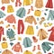 The seamless pattern with winter clothes. Coats, The vector set of winter clothes. Coats, hats, gloves, shoes and socks