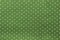 Seamless polka dots pattern on green fabric