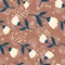 Seamless random pattern with folk flower silhouettes. Brown background with splashes. White and navy color flowers