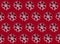 Seamless red fabric background with snowflakes