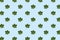 Seamless regular pattern with young green leaves of chestnut on a blue background.