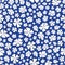 Seamless repeat pattern of stylized white outlined flowers on a dark blue background. A pretty tossed vector pattern