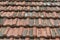 Seamless roof texture of flat red shingles with embedded line patterns.