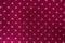 Seamless shiny polka dot wrapping paper. Raspberry foil for design of gift wrapping, wrapping paper, wallpaper. Stylish shiny