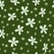 Seamless spring pattern with light green small rustic flowers on a dark green background. Doodle style