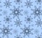 Seamless texture in blue colors with variety of snowflakes.