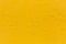 Seamless texture of flat thick painted yellow surface under direct sunlight
