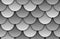 Seamless texture of grey rooftop background. Repeating gray pattern of silver fish scales roof tiles