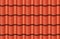 Seamless texture of red waves rooftop background. Repeating pattern of traditional ceramic roof tiles