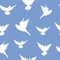 Seamless vector pattern with white pigeons on a blue background.