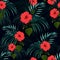 Seamless vector tropical pattern with dark palm leaves and tropical red hibiscus flowers on black background.