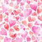 Seamless watercolor pattern with colorful hearts - romantic light and soft tints of pink and red.