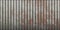 Seamless weathered rust corrugated metal fence texture. Crimp fluted metallic background