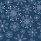 Seamless winter New Year pattern with white linear patterned snowflakes on a blue background. Christmas elegant and graceful print