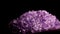 Seamlessly rotating a purple mineral Amethyst in front of black background.
