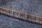 Seams on jeans close-up in high-resolution. Stitching on denim on the inside. Fabric texture. Blue jeans background and