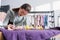 Seamstress marking fabric near blurred sewing