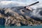 Seaplane Aircraft Flying over the Pacific Ocean Coast.