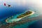 Seaplane approaching a tropical island in the Maldives