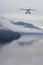 Seaplane flying over Canadian Mountain Nature Landscape on the Pacific West Coast