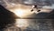 Seaplane flying over a Lake, trees and mountains in Canadian Landscape.