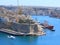 Seaplane flying over Valletta harbour