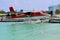 Seaplane landing on water port over turquoise water, Maldives