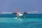 Seaplane at tropical beach resort. Luxury summer travel destination with seaplane in Maldives islands. Exotic vacation or holiday