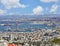 Seaport in the city of Haifa, panorama of the port and city buildings against the background of a blue sky with clouds.