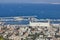 Seaport in the city of Haifa, panorama of the port and city buildings against the background of a blue sky with clouds.